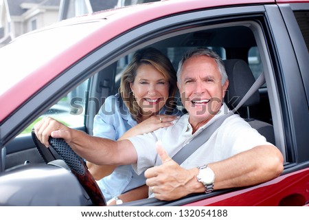 Happy senior couple in the car. Transportation.