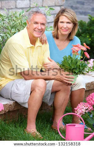 Happy senior couple in the garden. Gardening.