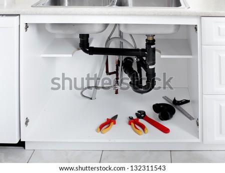Plumbing tools in the kitchen. Plumber service.