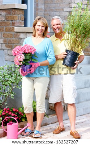 Happy senior couple in the garden. Gardening.