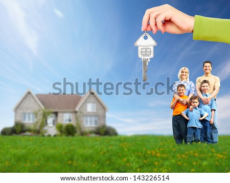 Happy family near new house. Real estate.