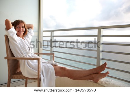 Woman on a balcony at Miami beach hotel.