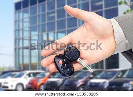 Hand giving a car key. Auto repair service.