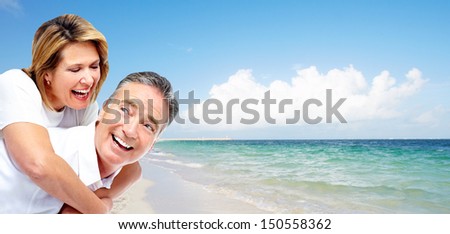Happy senior couple on a tropical beach. Caribbean vacation resort.