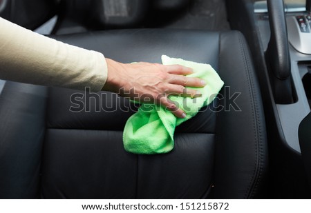 Hand cleaning car seat.