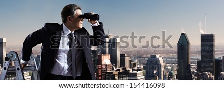 Businessman with binoculars. Search concept.