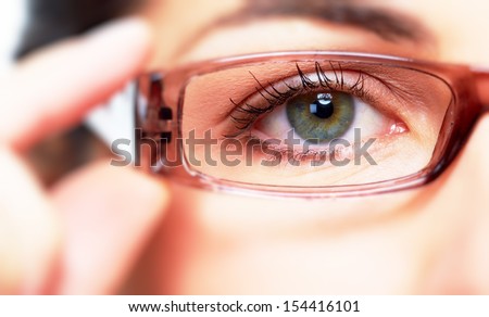 Eye Of Young Woman With Eyeglasses. Optometrist Concept Background