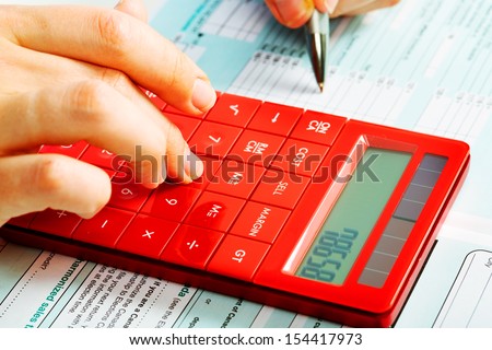 Hands Of Accountant With Calculator And Pen. Accounting Background.