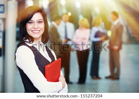 Bussinesswoman with red tablet over team background