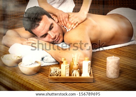 Handsome man relaxing in spa massage salon.