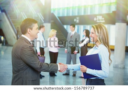 Two bussiness partners man and woman over team background