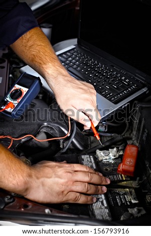 Auto mechanic working in garage. Repair service.