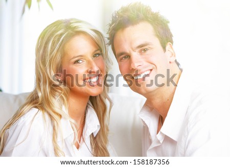 Happy couple at home. Mortgage and insurance concept.