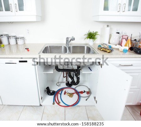 Kitchen sink pipes and drain. Plumbing service.