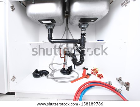 Kitchen sink pipes and drain. Plumbing service.