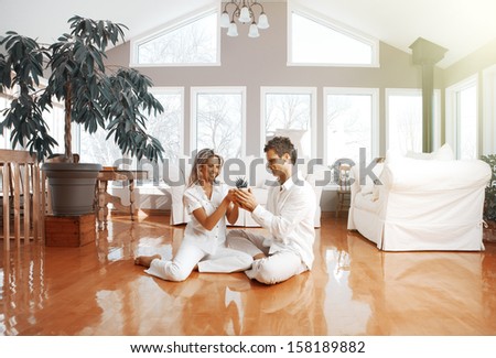 Happy couple at home. Mortgage and insurance concept.
