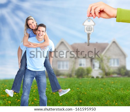 Happy family near new home. Real estate background.