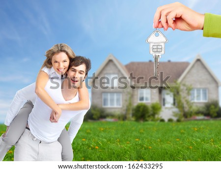 Happy Family Near New Home. Real Estate Background.