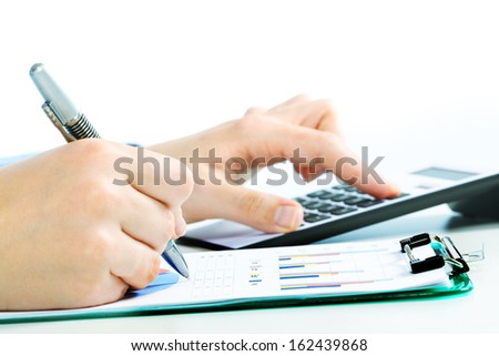 Hands of accountant with calculator and pen. Accounting background.