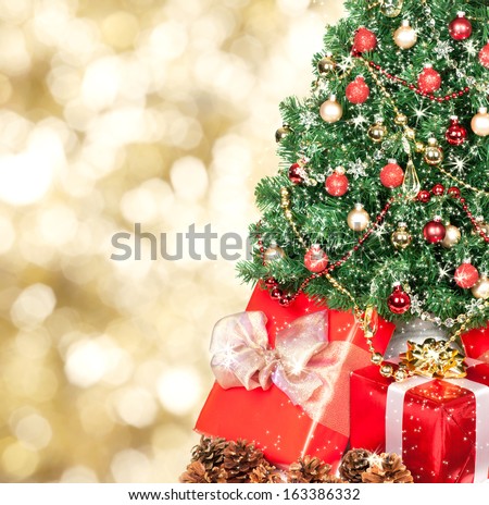 Christmas tree and gifts over golden sparkle background.