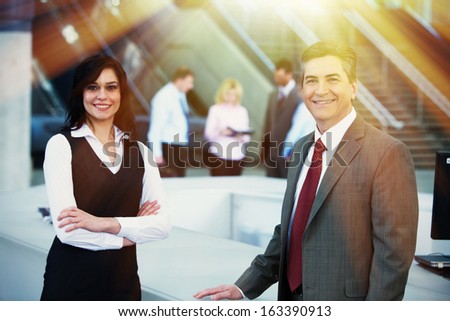 Two bussiness partners man and woman over team background