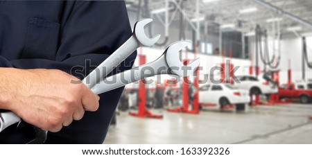 Hand of professional Auto mechanic with wrench.
