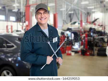 Auto mechanic with wrench. Car repair service.