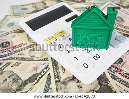 House money and calculator. Mortgage concept background.