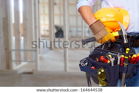 Worker With A Diy Tool Belt Over Construction Background