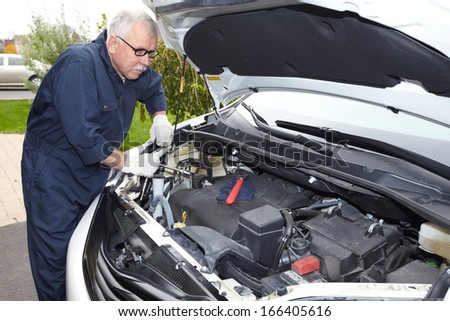 Car mechanic in uniform. Auto repair service.