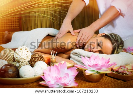 Beautiful woman having relaxing in spa massage salon.