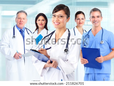 Group of medical doctors over blue hospital background