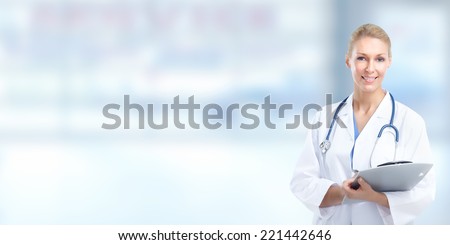 Beautiful smiling doctor woman over blue hospital background