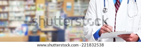 Hands of medical doctor writing prescription over blue background