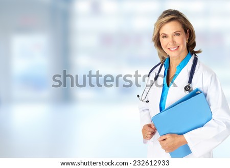 Beautiful mature doctor woman over blue hospital background