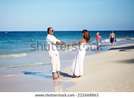 Happy couple dancing on the beach. Caribbean vacation