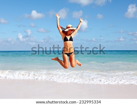 Young Girl jumping on the beach. Summer vacation