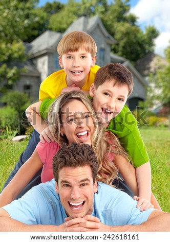 Happy family. Father, mother and children near new house