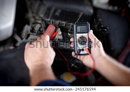 Mechanic working in auto repair garage. Car maintenance