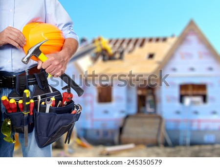 Construction worker with  tools in  new house. Renovation.
