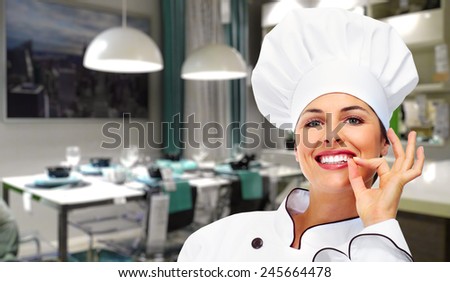 Young Chef woman in modern restaurant. Food.