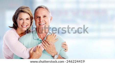 Happy senior loving couple over blue background