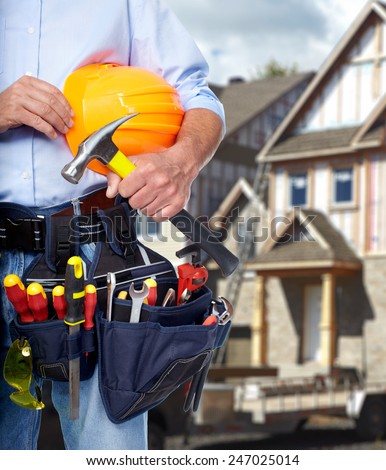 Construction worker with  tools in  new house. Renovation.