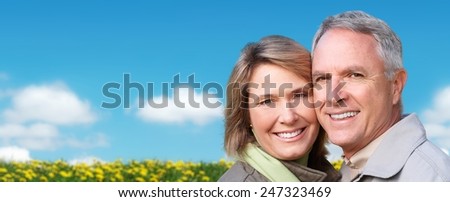 Happy senior loving couple over nature background
