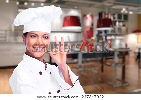 Smiling chef woman in the kitchen