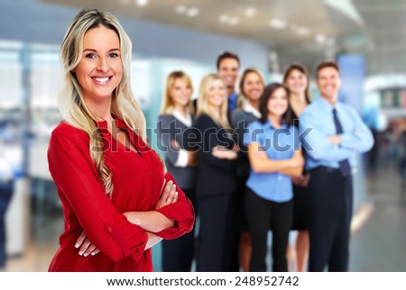 Young beautiful business woman over team background