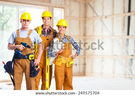 Group of professional construction workers in  new house. Renovation.