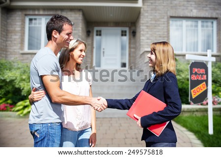 Happy Family near new home. Residential construction background.
