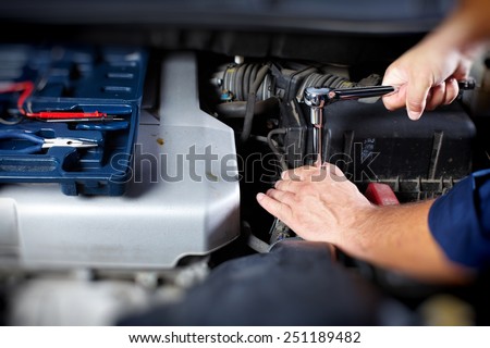Mechanic working in auto repair garage. Car maintenance