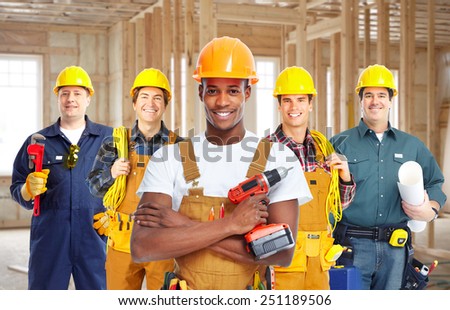 Group of professional construction workers in  new house. Renovation.